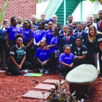 Students from both the Girlfriends of Pinellas and 5000 Role Models pose for a picture alongside Melrose Elementary faculty and representatives of the First United Methodist Church of St Petersburg.