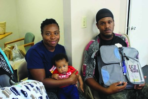 Parents, Kristen Burnett and Dequan Smith, holding their baby, Elijah Smith, benefited from the program at The Next Stepp Life Center.