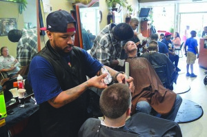 Barber Dale Jones cuts hair for free as part of Hair by Ahsile’s MLK Day of Service grant.
