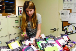 Shorecrest student, Ryan Healy, completes the finishing touches on the peace baskets assembled by her classmates Monday evening.