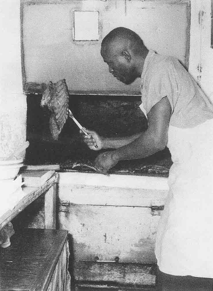 In this late 1950s photo, John “Geech” Black turns out some ribs in his barbecue stand’s kitchen. Courtesy Norman Jones II.